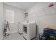 Laundry room featuring both washer and dryer, storage shelves and natural light at 2346 Mckenzie Ridge Ln, Apex, NC 27502