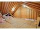 Unfinished attic with wood paneling and exposed beams, providing storage space at 2425 Lemuel Dr, Raleigh, NC 27615