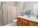 Bathroom with a white shower curtain, wooden vanity, large mirror and blue towels at 2425 Lemuel Dr, Raleigh, NC 27615