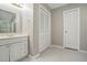 Bathroom with linoleum floors, a wooden vanity, white cabinets and a towel ring at 2425 Lemuel Dr, Raleigh, NC 27615