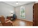 Bedroom featuring hardwood floors, neutral paint, ceiling fan, and a large window at 2425 Lemuel Dr, Raleigh, NC 27615