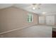 Spacious carpeted bedroom with a ceiling fan, large window, and double closet at 2425 Lemuel Dr, Raleigh, NC 27615