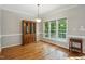 Elegant dining room showcasing hardwood floors and a large window with wooded views at 2425 Lemuel Dr, Raleigh, NC 27615