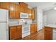 Kitchen features white appliances, ample cabinet space and hardwood floors at 2425 Lemuel Dr, Raleigh, NC 27615