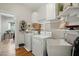 Laundry room with white washer, dryer, cabinets, and a utility sink at 2425 Lemuel Dr, Raleigh, NC 27615