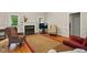 Cozy living room featuring a fireplace, hardwood flooring, and comfortable seating arrangements at 2425 Lemuel Dr, Raleigh, NC 27615