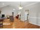 Open living room with vaulted ceilings, hardwood floors, and view to kitchen at 2425 Lemuel Dr, Raleigh, NC 27615