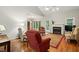 Bright living room featuring a fireplace, hardwood floors, and views of the outdoor scenery at 2425 Lemuel Dr, Raleigh, NC 27615