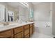 Main bathroom features dual sink vanity, soaking tub and walk-in closet at 2425 Lemuel Dr, Raleigh, NC 27615