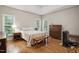 Spacious main bedroom with hardwood floors, two windows, and ample closet space at 2425 Lemuel Dr, Raleigh, NC 27615