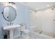 The blue and white bathroom offers a glass enclosed shower with a built in bench and unique tile floors at 2508 Kearney Rd, Wake Forest, NC 27587
