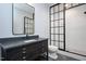 Bathroom boasting a black vanity with granite counters, black hardware, and black framed glass shower at 2508 Kearney Rd, Wake Forest, NC 27587