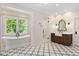 Luxurious bathroom with soaking tub, glass shower, patterned tile floor, and wooden vanity at 2508 Kearney Rd, Wake Forest, NC 27587