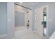 Bright bathroom with blue walls, hexagon tile floor, a shower-tub combo with decorative tiles, and black hardware at 2508 Kearney Rd, Wake Forest, NC 27587