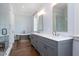 Modern bathroom with double vanity, soaking tub, glass enclosed shower and wood floors at 2508 Kearney Rd, Wake Forest, NC 27587