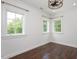 Inviting bedroom with wood floors, shiplap walls and natural light from the three windows at 2508 Kearney Rd, Wake Forest, NC 27587