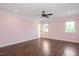 Light-filled bedroom showcases wood floors, a ceiling fan, and two windows with bright trim at 2508 Kearney Rd, Wake Forest, NC 27587