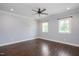 Spacious bedroom with hardwood floors, neutral paint, a ceiling fan, and natural light from two windows at 2508 Kearney Rd, Wake Forest, NC 27587
