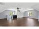 A bonus room offers a bar with black cabinets, hardwood floors, and multiple windows for natural light at 2508 Kearney Rd, Wake Forest, NC 27587