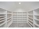 Unfinished bonus room above the garage features carpeted floors and built-in white shelving at 2508 Kearney Rd, Wake Forest, NC 27587