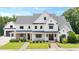 Beautiful white exterior with manicured lawn and covered porch seating area at 2508 Kearney Rd, Wake Forest, NC 27587