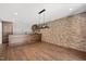 A modern kitchen featuring a brick wall and dark wood accents at 2508 Kearney Rd, Wake Forest, NC 27587