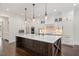 Gourmet kitchen boasts white cabinetry, a large marble island, and stainless steel appliances at 2508 Kearney Rd, Wake Forest, NC 27587