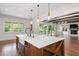 Elegant kitchen featuring a large marble island, stainless steel sink, and open views of the living room at 2508 Kearney Rd, Wake Forest, NC 27587