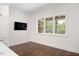 Bright living room features dark wood floors, white walls and built-in cabinets flanking a large window at 2508 Kearney Rd, Wake Forest, NC 27587