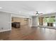 Spacious living room featuring a brick accent wall, wood floors, an island with sink, and sliding glass doors at 2508 Kearney Rd, Wake Forest, NC 27587