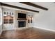 Spacious living room with fireplace, exposed beams, built-in cabinets, and hardwood flooring at 2508 Kearney Rd, Wake Forest, NC 27587