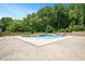 The backyard features an in-ground pool, comfortable lounging and a surrounding brick wall for privacy at 2508 Kearney Rd, Wake Forest, NC 27587