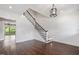 Staircase with dark wood floors and a view to a sunroom at 2508 Kearney Rd, Wake Forest, NC 27587