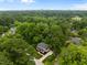 This aerial view captures a home with mature trees, lush landscaping and a paved driveway at 2551 Drake Ave, Durham, NC 27705