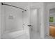 Bathroom features subway tile in shower/bath and white hexagon tile floor at 2551 Drake Ave, Durham, NC 27705