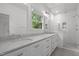 Bathroom with double vanity, marble counters, subway tile and glass enclosed shower at 2551 Drake Ave, Durham, NC 27705
