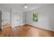 Bedroom with hardwood floors, a window, and closet and shelf storage in a minimalist design at 2551 Drake Ave, Durham, NC 27705