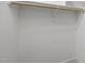 Walk-in closet with a wooden hanging bar and white walls at 2551 Drake Ave, Durham, NC 27705
