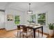 Elegant dining room features hardwood floors, natural light, and modern chandelier at 2551 Drake Ave, Durham, NC 27705