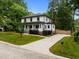 Two-story home has white siding, covered porch, and long driveway at 2551 Drake Ave, Durham, NC 27705