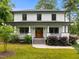 Inviting two-story home with a classic design, featuring a covered front porch and well-maintained yard at 2551 Drake Ave, Durham, NC 27705