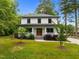 Two-story home has white siding, covered porch, and a manicured lawn at 2551 Drake Ave, Durham, NC 27705