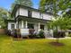 Charming two-story home with a welcoming front porch, lush landscaping, and a well-manicured lawn at 2551 Drake Ave, Durham, NC 27705