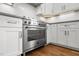 Close up of stainless steel oven and white cabinets with stylish hardware and herringbone backsplash at 2551 Drake Ave, Durham, NC 27705
