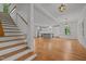 Spacious living room with hardwood floors, open to kitchen, and staircase, perfect for modern living at 2551 Drake Ave, Durham, NC 27705