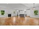 Open-concept living space features hardwood floors, a cozy fireplace, and a modern kitchen with island seating at 2551 Drake Ave, Durham, NC 27705