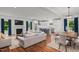 Bright, open-concept living space with fireplace, dining area, and modern kitchen with stainless steel appliances at 2551 Drake Ave, Durham, NC 27705