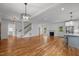 Spacious living room with hardwood floors, open floor plan, and modern kitchen, creating an inviting atmosphere at 2551 Drake Ave, Durham, NC 27705