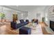 Open concept living room with a fireplace, hardwood floors, a staircase and stylish furniture at 2551 Drake Ave, Durham, NC 27705