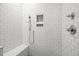 Close up of a subway tiled shower featuring a bench and a handheld sprayer at 2551 Drake Ave, Durham, NC 27705